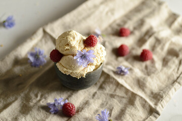 Obraz na płótnie Canvas ice cream in a ceramic bowl with raspberries