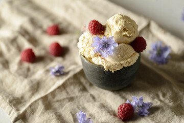 ice cream in a ceramic bowl with raspberries