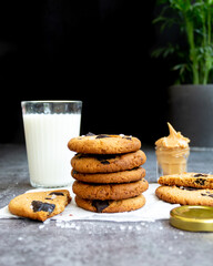 Peanut Butter and Chocolate cookies - styled shot with a glass of milk and peanut butter