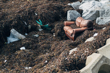 Sofa and other garbage on a beach in Galway, Ireland