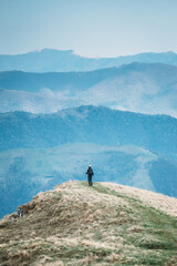 Woman hiking against the backdrop of beautiful mountains in Ticino, Switzerland