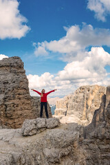 Obraz premium Active hiker hiking, enjoying the view, looking at Dolomites mountains landscape