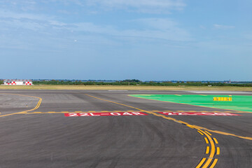 runway of airport with cloudy sky