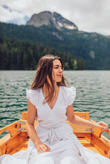 Young woman enjoying in boat on lake