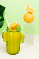 Orange juice glass with fruit decoration on ice block. Copy space.