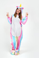 Girl in a purple unicorn costume in the studio on a white background.