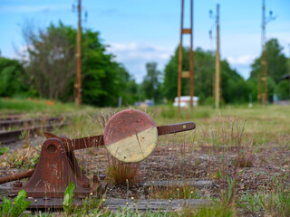 Rusty gear by railroad track. Grass and weeds showing. Shot in Sweden, Scandinavia