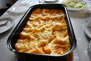 Ready to eat lasagna on a gray dinning table with dinning set