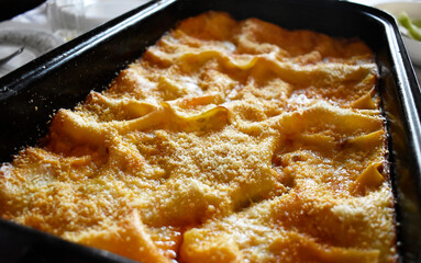 A close up shot of traditional Italian food - Lasagna, ready to eat on a dining table