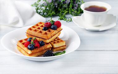 Viennese waffles, with berries, on a white table, breakfast, no people, horizontal,
