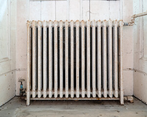 Old, cast iron radiator in abandoned house.