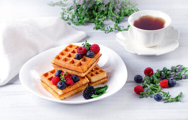 Viennese waffles, with berries, on a white table, breakfast, no people, horizontal,