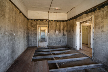Abandoned building interior in Kolmanskop, a ghost town in the Namib desert near Luderitz, Namibia, southwest Africa.
