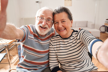 Senior people making selfie while sitting at the table at the retirement house