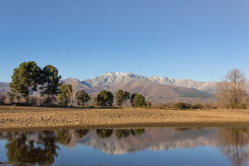 Gredos mountain with the Almanzor peak, in Spain, reflected in the water of a swamp. Winter landscape with a little snow on the peaks. Tourism.