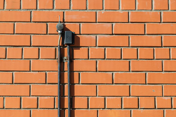 Two state sensors on a brick wall.