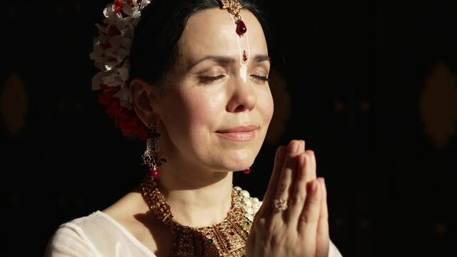 Hare Krishna Woman in namaste position