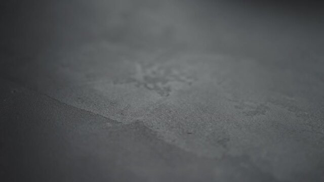 Slow motion handheld shot of gray concrete surface