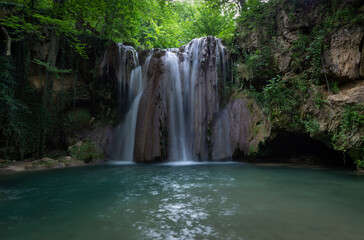 Fototapeta na wymiar Beautiful Blederija waterfall in the forest of Eastern Serbia, near Kladovo.