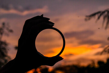 silhouette of a person with a ring
