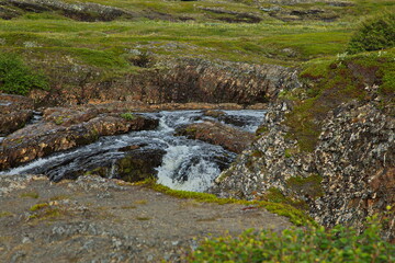 Naklejka na ściany i meble Waterfall on the river in the Kola tundra.