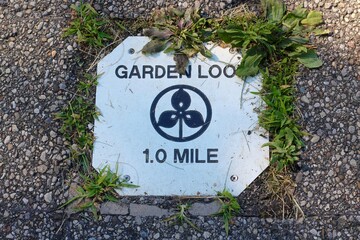 A close view of the old metal mile distance sign.