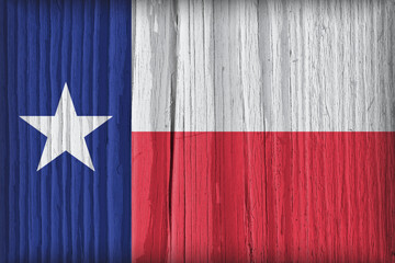 The flag of the state of Texas on a dry wooden surface. Bright wallpaper or illustration made of old wood. Lone Star Flag with vignetting