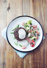 Fried hamburger steak with fresh salad. Wooden background. Top view. Copy space. 