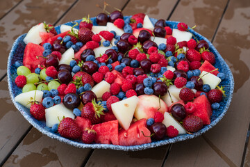 assorted fruits and berries on a plate. summer harvest. 