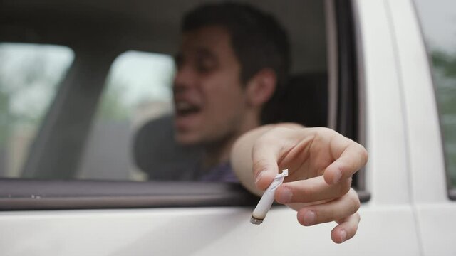 Man smokes weed in the car