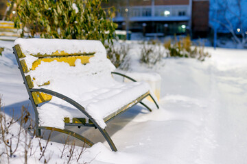park bench completely covered with snow