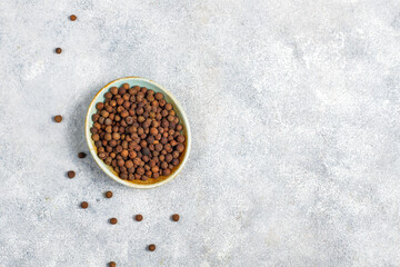 Allspice in a small bowl and spoon.