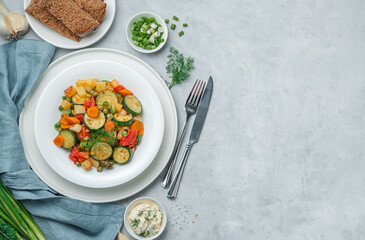A portion of fried vegetables on a gray background with space for copying.