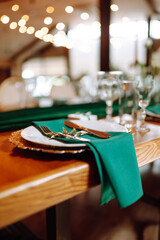 Wedding. Banquet. Beautiful table setting for a party, wedding reception or other festive event emerald colour.