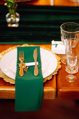 Wedding. Banquet. Beautiful table setting for a party, wedding reception or other festive event emerald colour.