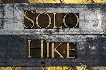 Solo Hike text on vintage textured grunge copper and gold background