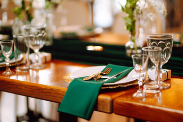 Wedding. Banquet. Beautiful table setting for a party, wedding reception or other festive event emerald colour.