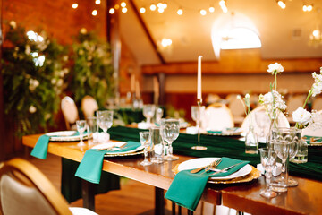 Wedding. Banquet. Beautiful table setting for a party, wedding reception or other festive event emerald colour.