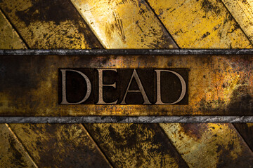 Dead text on vintage textured grunge copper and gold background
