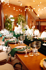 Fototapeta na wymiar Wedding. Banquet. Beautiful table setting for a party, wedding reception or other festive event emerald colour.