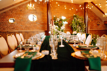 Wedding. Banquet. Beautiful table setting for a party, wedding reception or other festive event emerald colour.