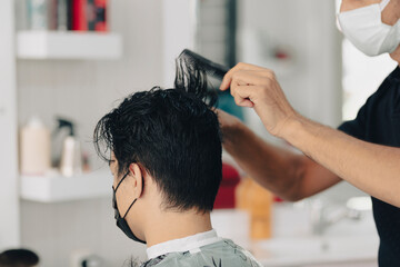 Haircut at a men's barbershop.Haircut with scissors