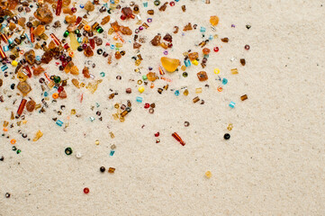 Stars falling. amber and beads on white sand background.