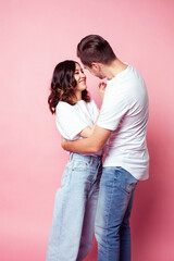 young cheerful caucasian couple together having fun on pink background, guy ang girl modern relationship, lifestyle people concept