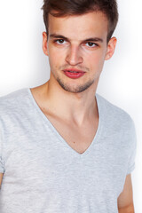 Obraz premium young handsome teenage hipster guy posing emotional, happy smiling against white background isolated, lifestyle people concept