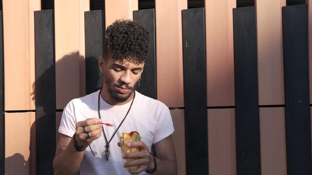 latin man eating fresh fruit - healthy lifestyle concept