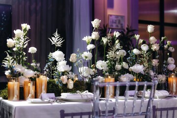 Romantic Wedding Table Top Layout Decor with large lush floral bouquets including white roses, ranunculus, persian buttercups, white orchids and candles