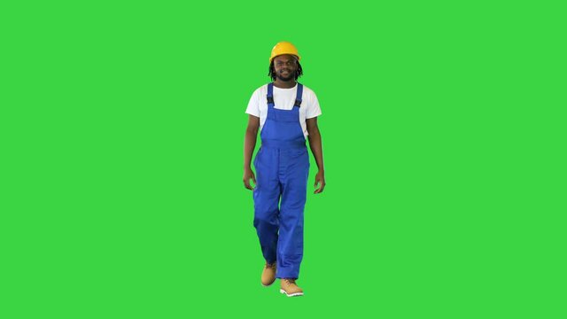 Walking african american construction worker on a Green Screen, Chroma Key.
