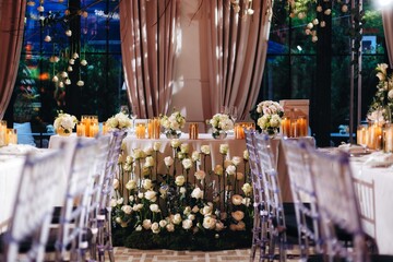 Romantic Wedding Table Top Layout Decor with large lush floral bouquets including white roses, ranunculus, persian buttercups, white orchids and candles