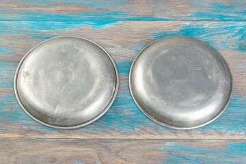 Old metal plates for scales on wooden background.